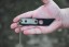 TOPS ALRT XL-03 compact fixed blade knife featuring a black utility blade with a durable angular tip and black canvas micarta handles.