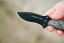 TOPS Desert Son compact fixed blade knife featuring a black recurve blade with jimping and a layered, light-toned ergonomic Black Linen Micarta handle.
