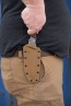 Viking Tactics Norseman fixed blade knife secured in its Coyote Tan Kydex sheath with MOLLE-Loks attached.